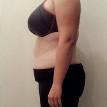 Person wearing a black tank top and feeling debloated before using energyze