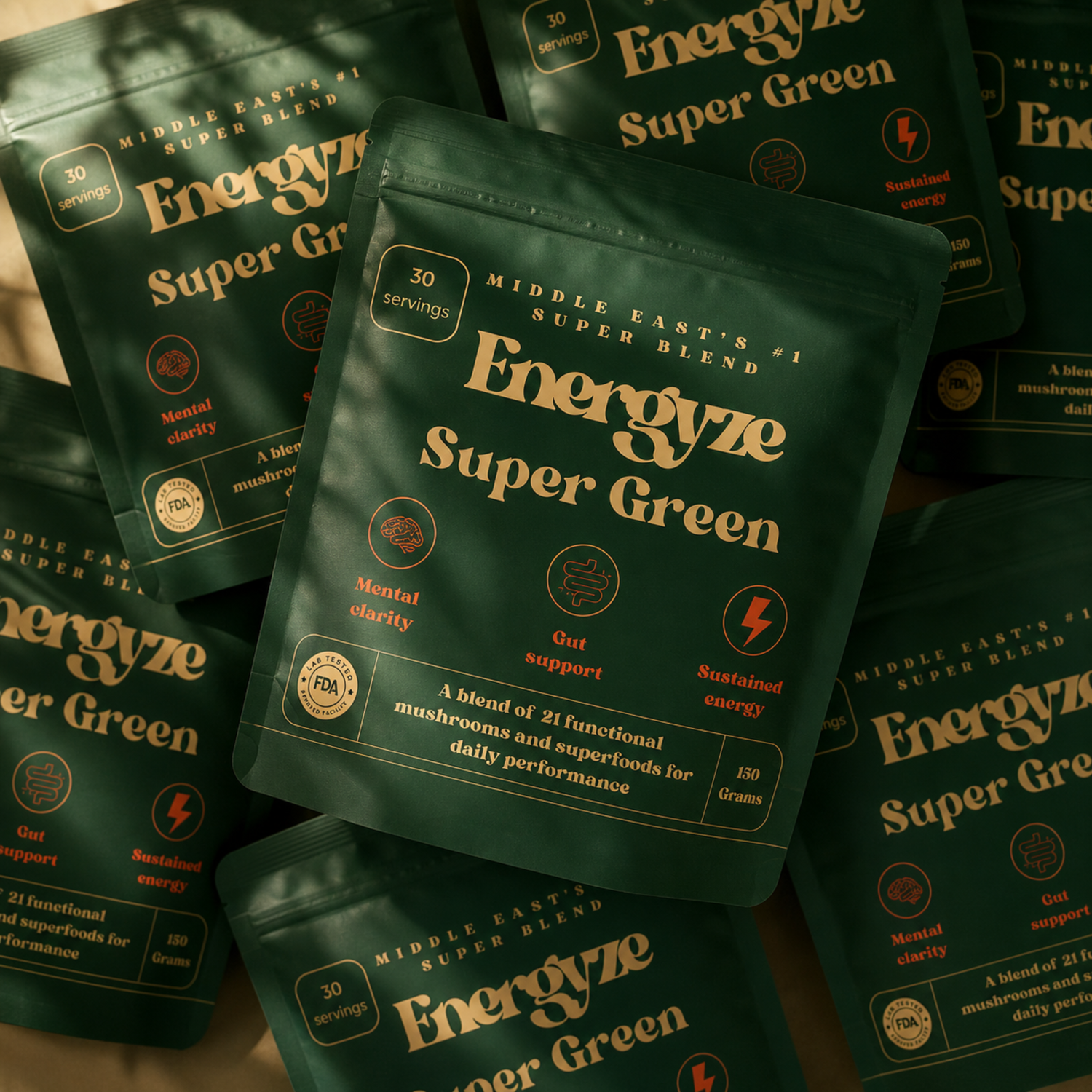 Multiple Energyze Super Green powder pouches arranged on a blurred natural background
